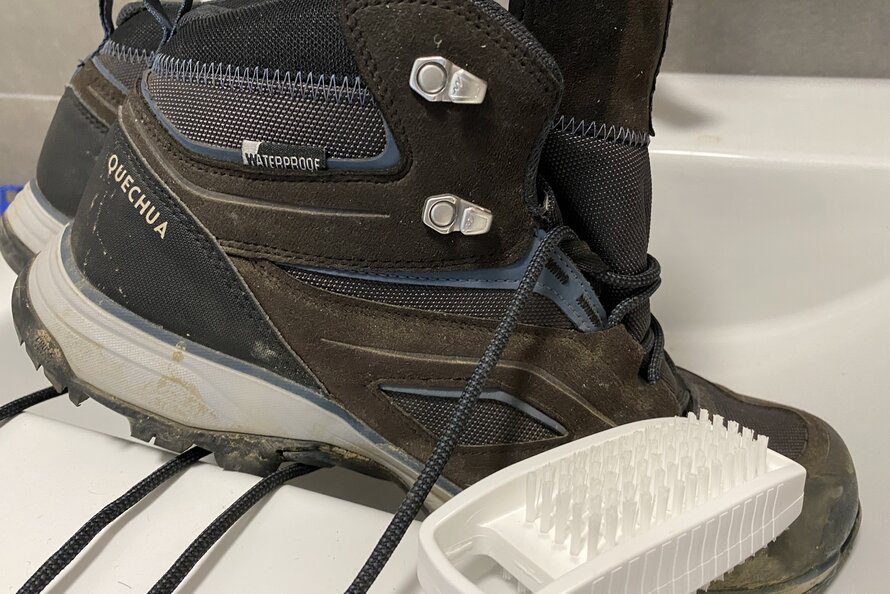 cleaning hiking boots with a brush