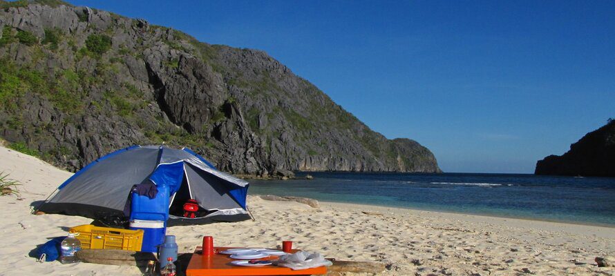 blue tent and table on the beach