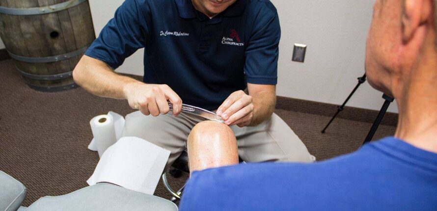 doctor treating knee pain