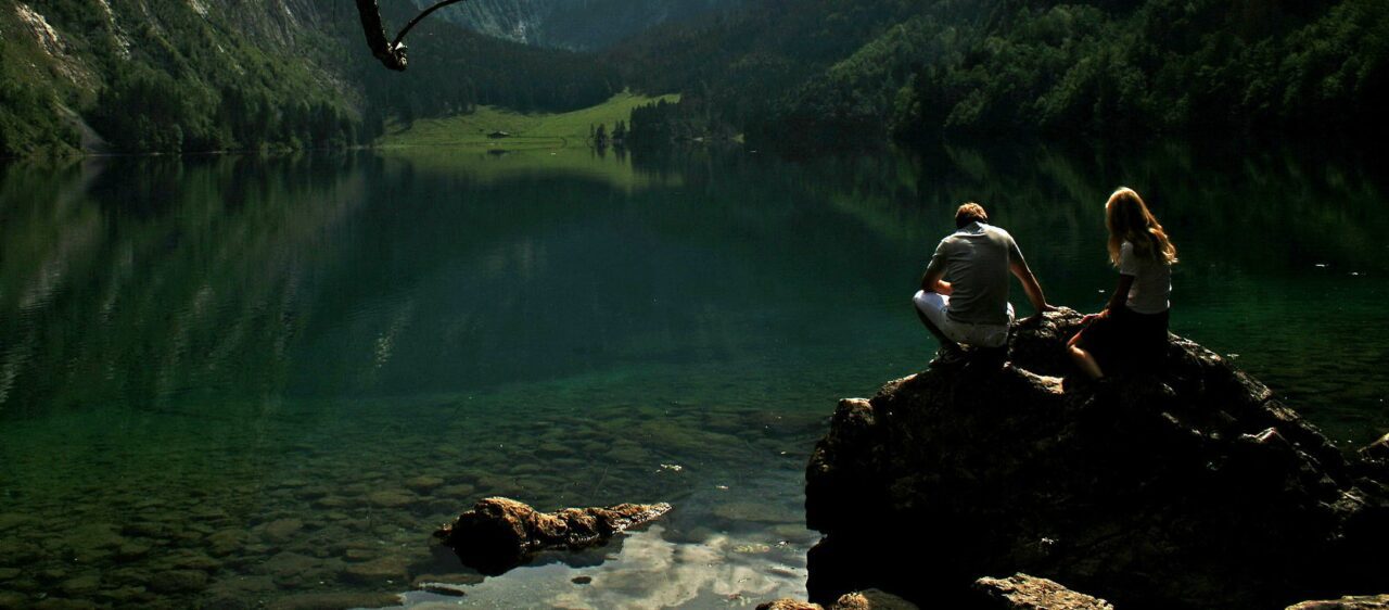 man and woman looking at river