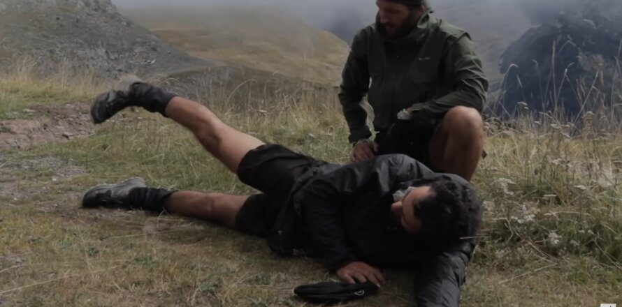 man laying down stretching knees