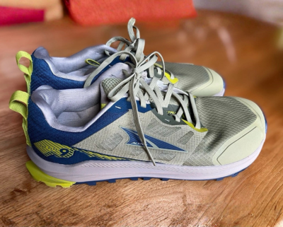 10 Best Vegan Hiking Boots (2026 Tested, Reviewed & Ranked) An Altra Lone Peak 9 pair on a wooden surface