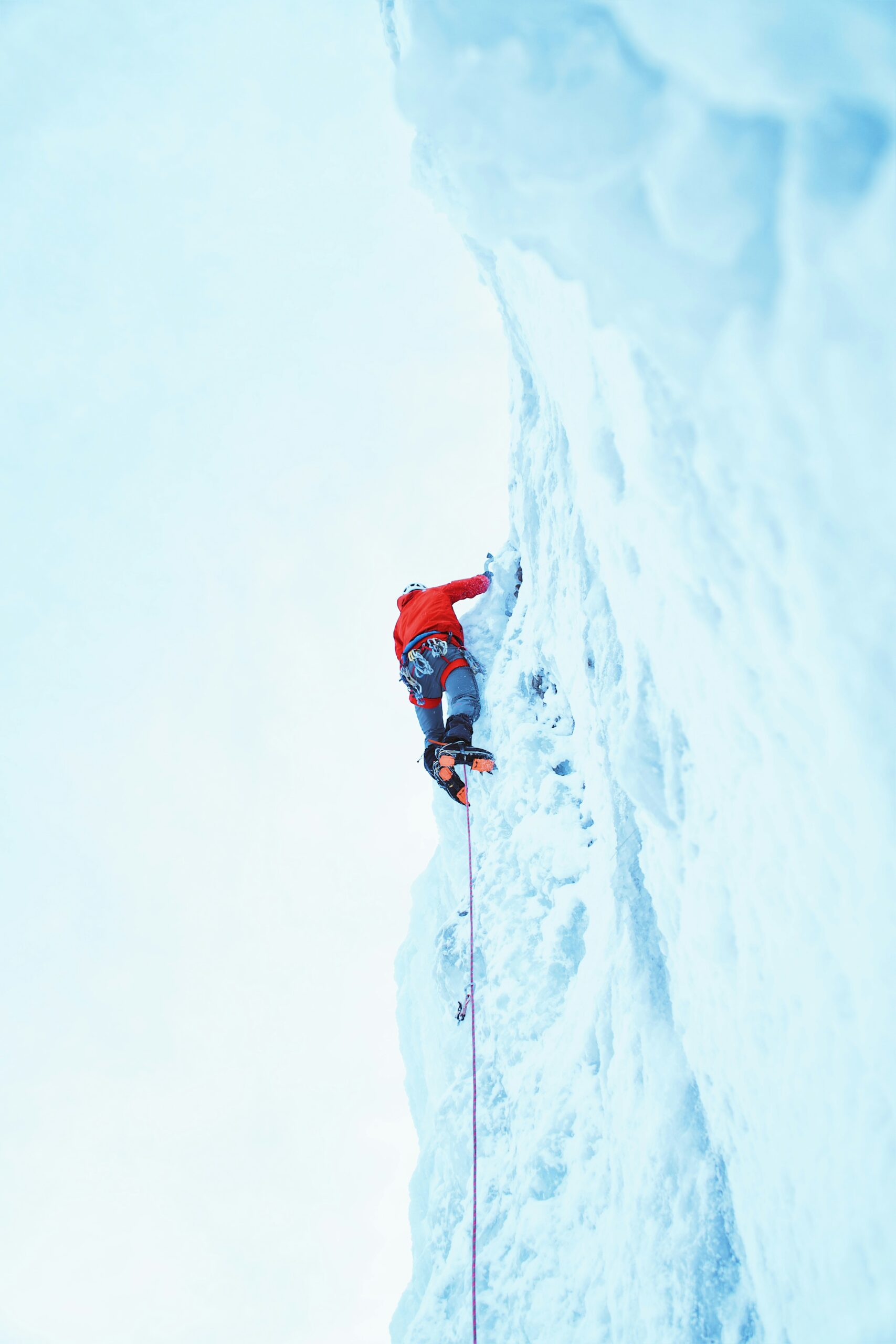 Alpinism vs. Mountaineering: Key Differences Explained Ice climbing with ice axes and crampons