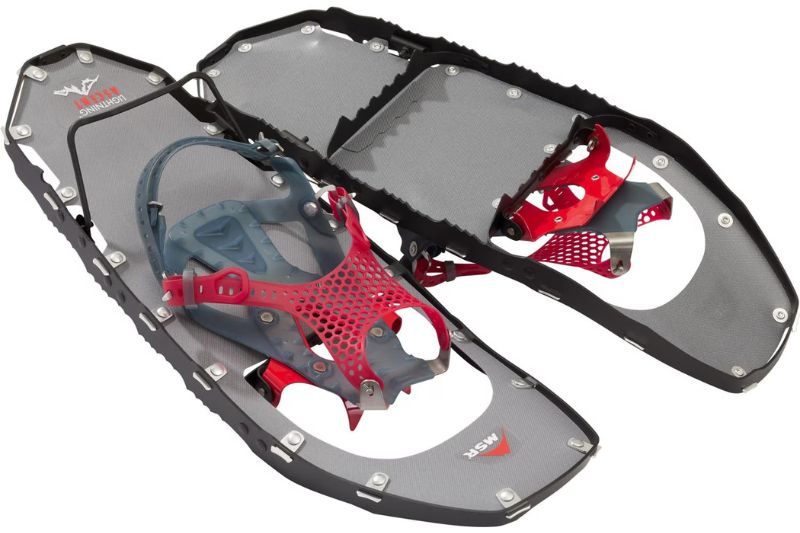 7 Best Snowshoes For Winter Hiking & Mountaineering A pair of modern snowshoes with durable, gray frames and red and gray bindings, designed for winter hiking and snowy terrain navigation.