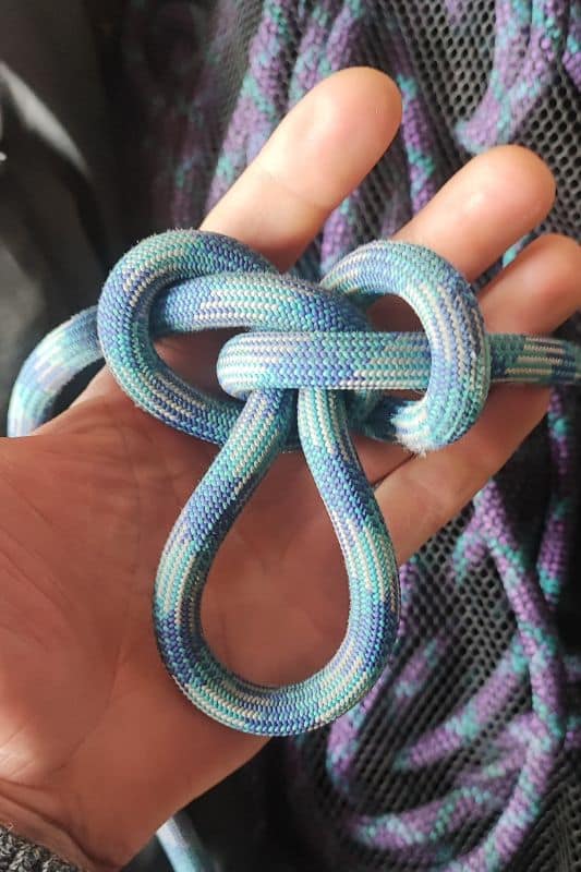 Essential Rope Skills & Knots for Mountaineering Example of the Alpine Butterfly knot made with a blue rope.
