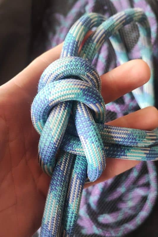 Essential Rope Skills & Knots for Mountaineering Example of the Bowline on a Bight knot made with a blue rope.