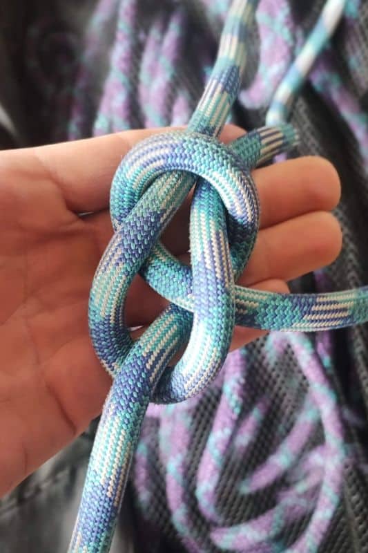 Essential Rope Skills & Knots for Mountaineering Example of the Bowline knot made with a blue rope.