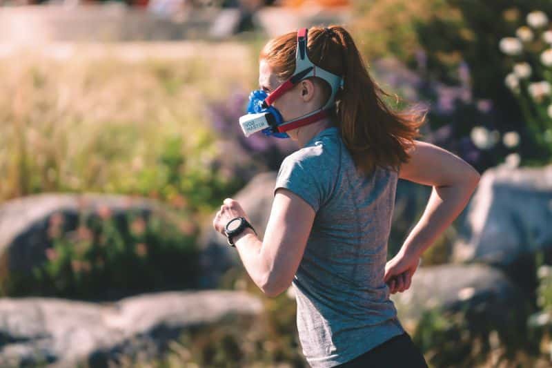 Altitude Sickness Guide: Symptoms & Prevention Women training with a V02 mask on