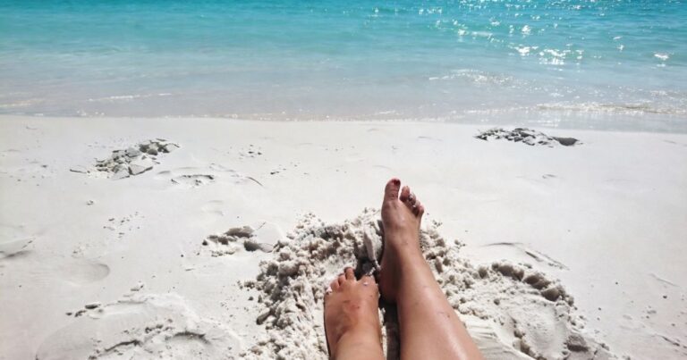 Hiking With Flat Feet: Expert Guide to Stronger Arches on the Trail Feet in the sand on the beach, near the water