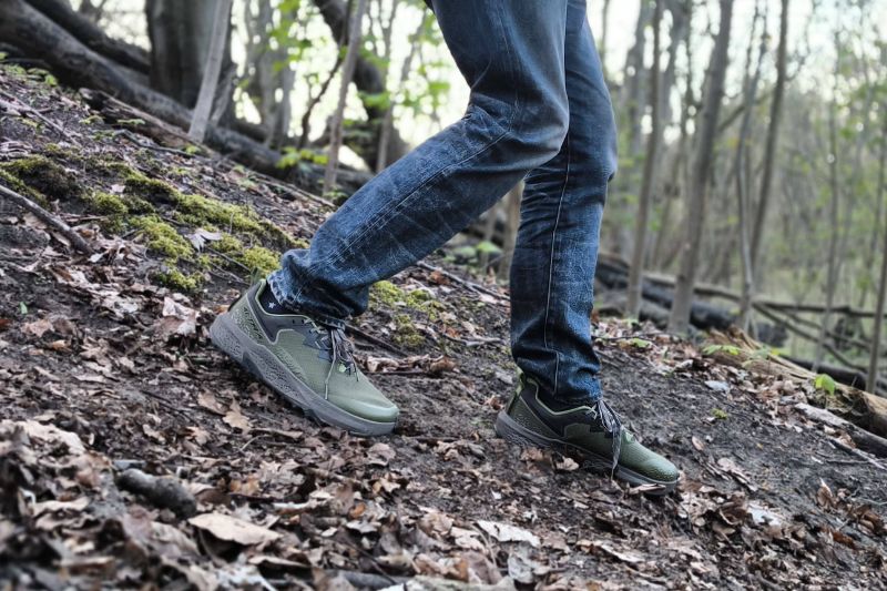 Hiking With Flat Feet: Expert Guide to Stronger Arches on the Trail Someone walking downhill and clearly having to put effort into keeping control