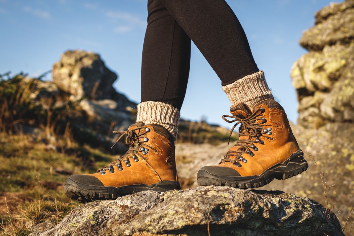 Ankle Strengthening Exercises for Hikers: A 3-Stage Progression Hiker wearing supportive boots while hiking on rocky terrain after recovering from an ankle sprain