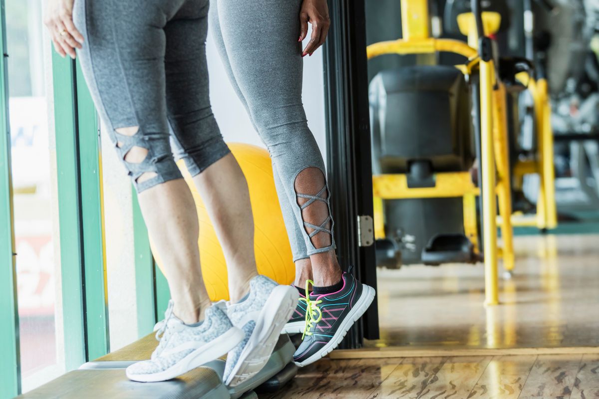 Person performing negative calf raises on a step to strengthen the calves and ankles