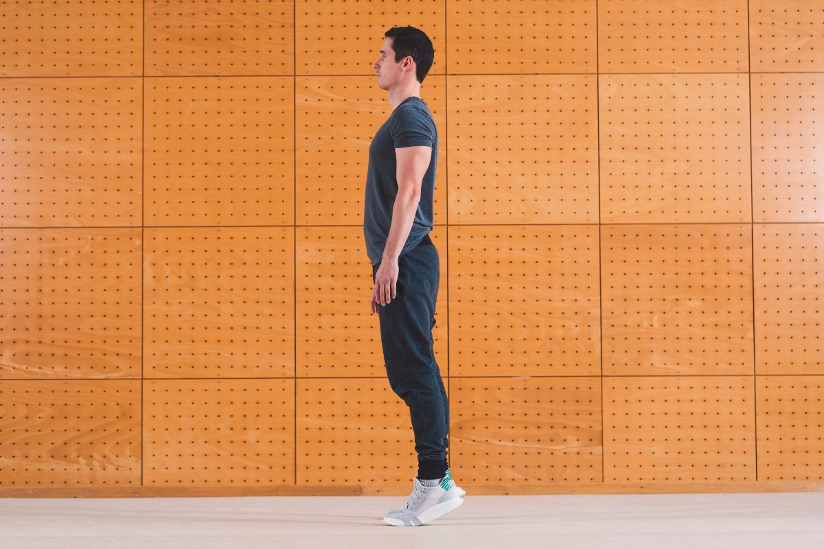 Ankle Strengthening Exercises for Hikers: A 3-Stage Progression Person performing standing heel raises, some of the best ankle strengthening exercises for hikers to strengthen the calves and ankle stabilisers