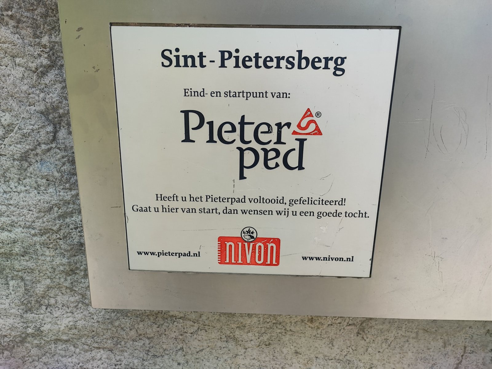 I Walked Four Days of the Pieterpad Without Booking a Single Bed Nivon plaque on a stone wall reading Sint-Pietersberg, end and start point of the Pieterpad.