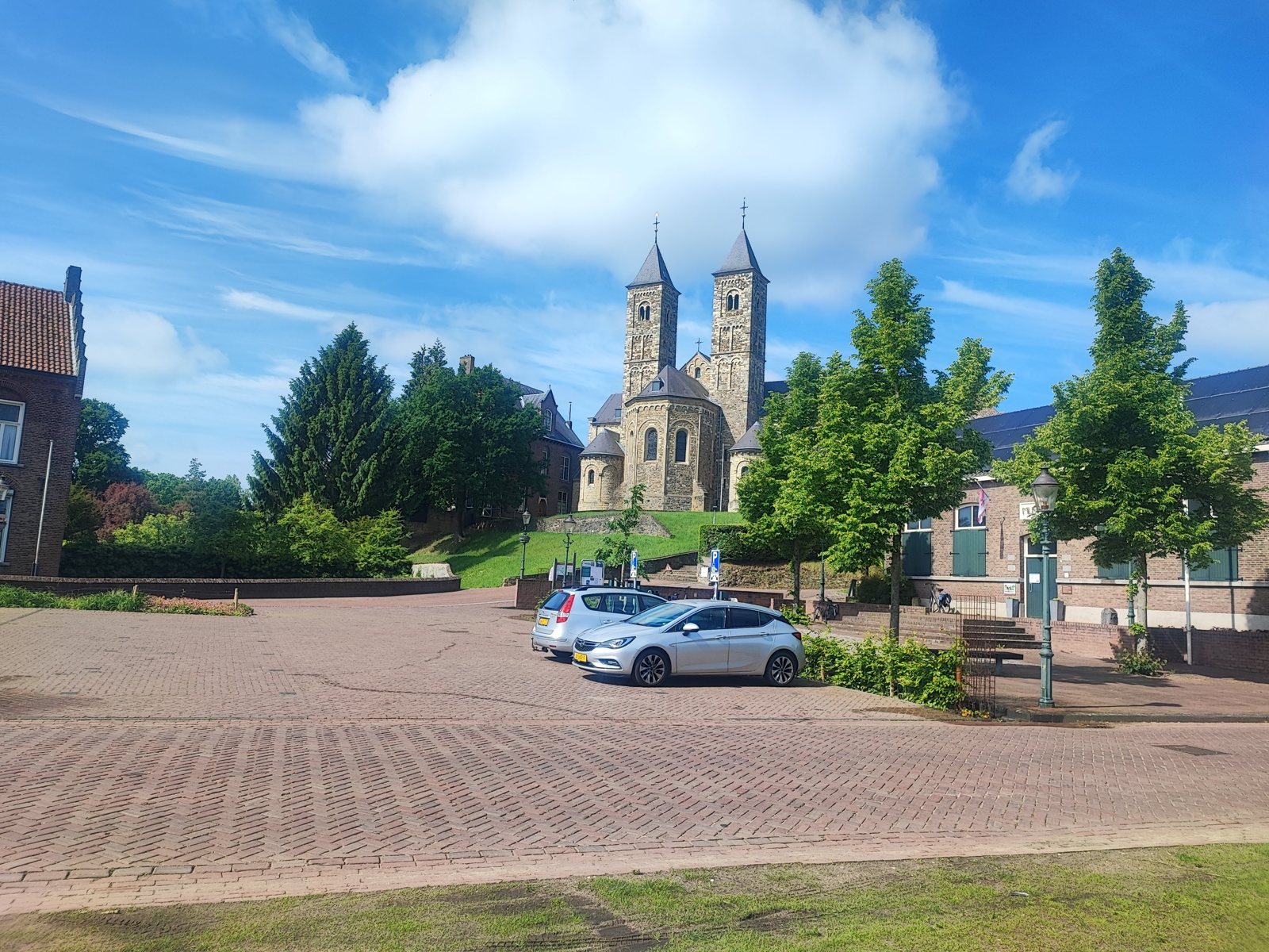 I Walked Four Days of the Pieterpad Without Booking a Single Bed Twin-towered Romanesque basilica seen across a brick square under a blue sky.