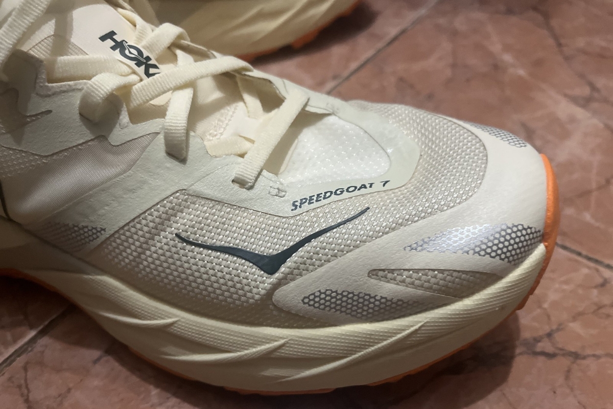 Close-up of the woven RPET upper and dynamic vamp on the HOKA Speedgoat 7 forefoot