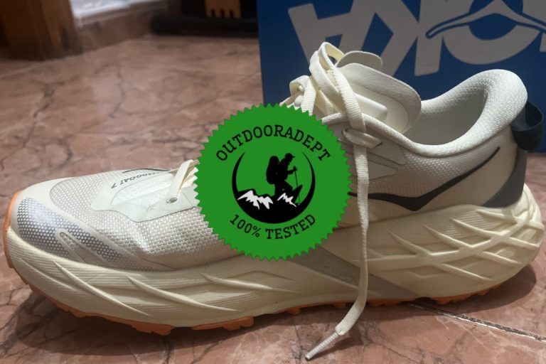 Women's HOKA Speedgoat 7 trail running shoe in cream and orange, side view, tested by OutdoorAdept