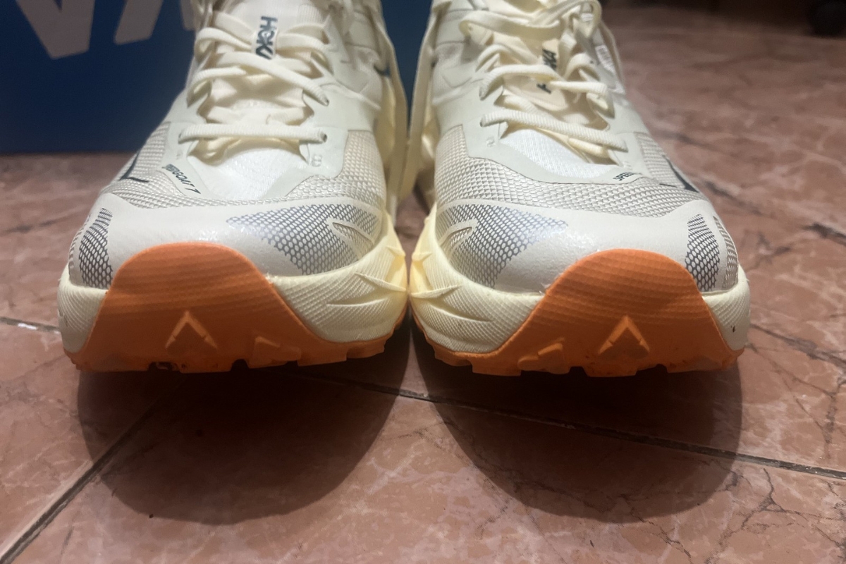 Close-up of the rubber toe caps on a pair of HOKA Speedgoat 7 trail shoes after rock contact