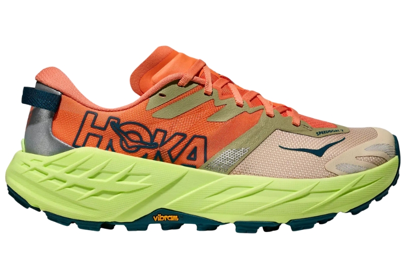 HOKA Speedgoat 7 trail running shoe in orange with a lime supercritical foam midsole and Vibram outsole, side view