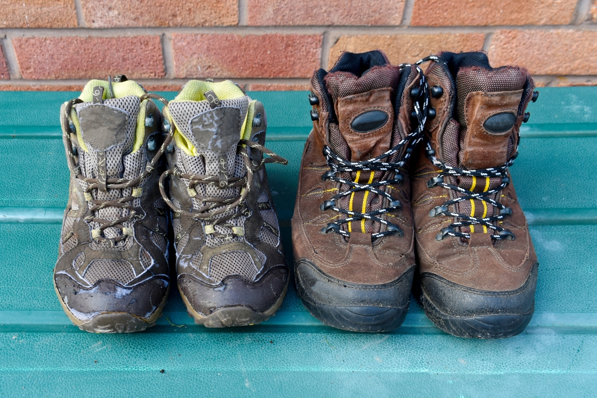 Two pairs of worn hiking boots showing different designs