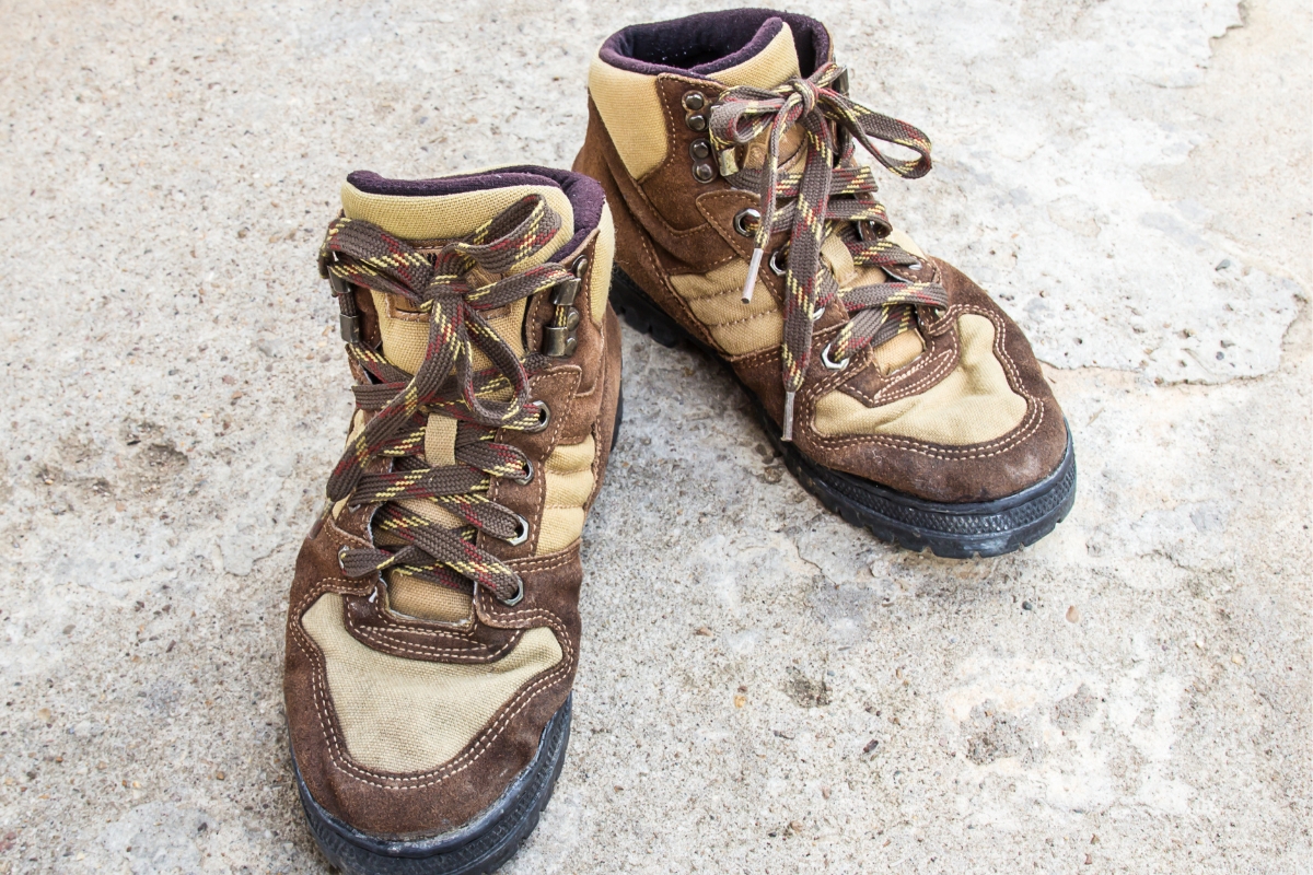 How to Choose Hiking Boots: A Field Tester's Guide (2026) A pair of older brown hiking boots showing signs of wear