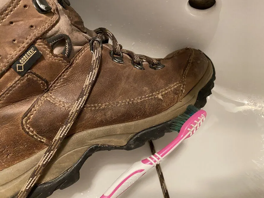 cleaning my leather hiking boots with a toothbrush