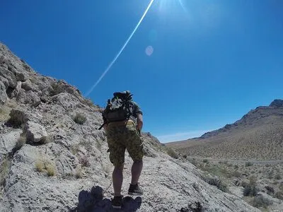 A man exercising to strengthen his ankles by going up the mountain