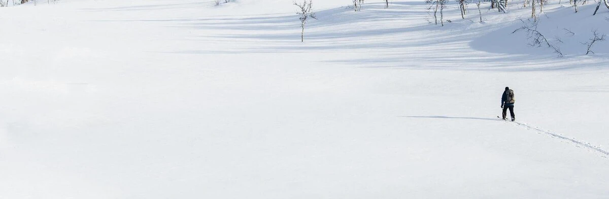 person hiking in the winter on the snow