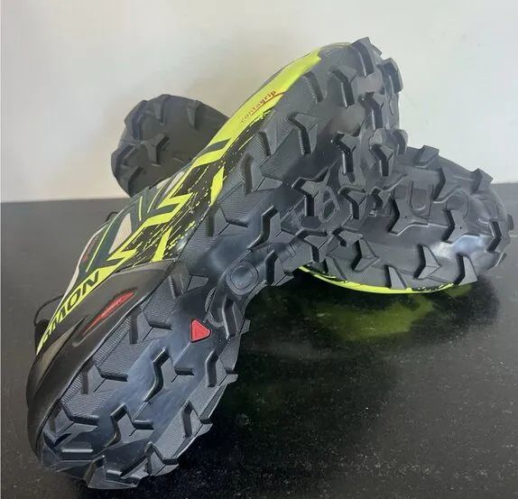 5 Best Waterproof Trail Running Shoes (Top Picks of 2026) salomon speedcross 6 gtx model pair laying on a black surface. the lugs are clearly visible